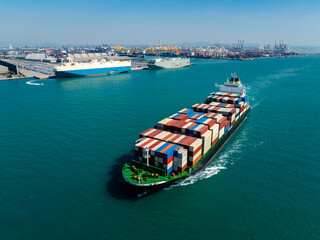Aerial view of container ship passing car carrier at port for multimodal transport business