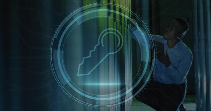 Animation of security key icon over african american male engineer using tablet at server room