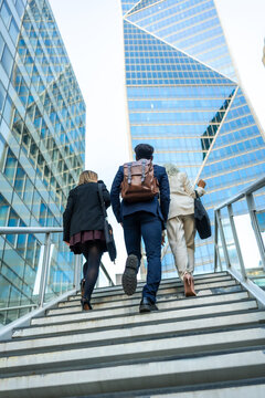 Business people colleagues walking up stairs in modern city