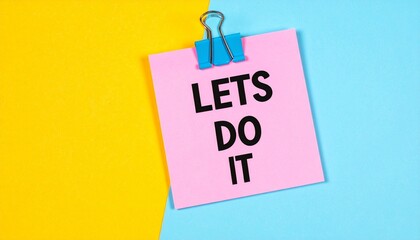 "LETS DO IT" on pink note clipped over yellow-blue split.