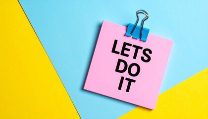 "LETS DO IT" on pink note clipped over yellow-blue split.