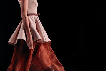 Chic elegant satin brown skirt and beige blouse, fashion woman's luxury outfit on black background