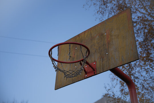 an old basketball hoop. the torn grid