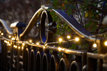 Metal fence panel with Christmass string lights