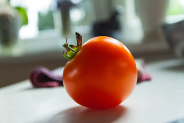 The tomato is on the counter
