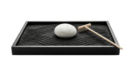 Desktop zen garden with black sand white stone and rake. Mindfulness stress relief tool.