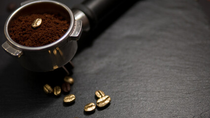 Espresso portafilter filled with ground coffee featuring a single golden coffee bean, surrounded by...