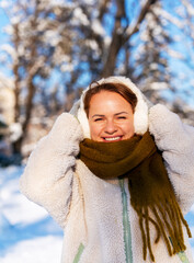 Portrait of happy young woman outdoors in winter.