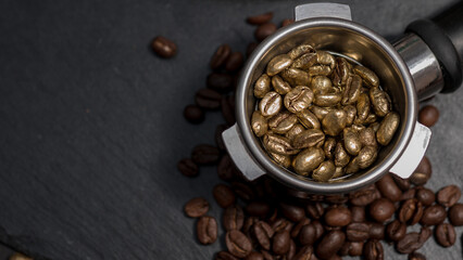 Top view of golden coffee beans filled in an espresso portafilter, surrounded by regular roasted...