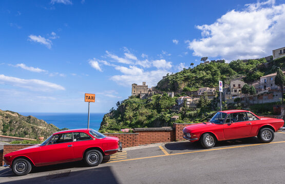 Savoca, Italy - May 5, 2019: Lancia Fulvia Coupe cars in Savoca, Church of San Nicolo also known as Church of San Lucia on background, Sicily