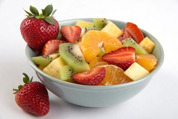 Fresh Fruit Salad in a Bowl Isolated on White Background