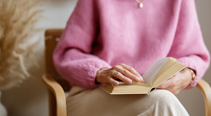 Sitting comfortably, a woman in a pink sweater turns pages of a book, embracing peaceful solitude Generative AI