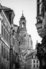 Frauenkirche rises above the buildings in Dresden. The dome is a prominent feature of the church and attracts visitors during the Christmas season. Streets are quiet in the winter light.