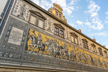 This mural The Procession of Princes displays a mounted procession of Saxony's rulers. It is located on the wall of a building in Dresden. Visitors can view this artwork showcasing history and culture