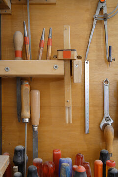 Carpentry tools organized on wooden wall in Schaeftlarn workshop