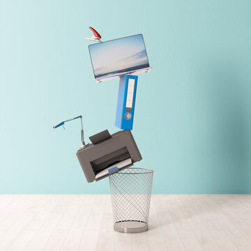 Symbolic stack of office items balancing above trash bin indoors
