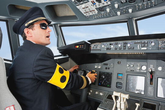 Pilot with blind armlet operating airplane cockpit at Bavaria Studio