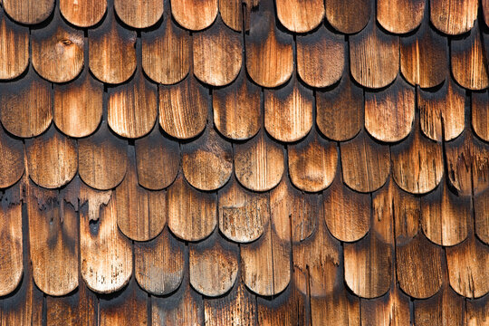 Weathered wooden shingle facade detail on house in Austria