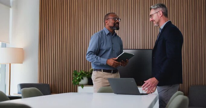 Mature businessman, handshake and tablet at office for b2b agreement, thanks and talk at insurance company. People, happy and shaking hands with deal, support and success at risk management agency