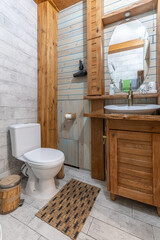 Rustic bathroom interior with wooden vanity and vessel sink