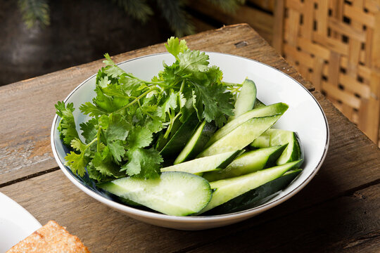 This traditional Malay ulam features fresh coriander leaves and Japanese cucumber served raw highlighting crisp texture natural freshness and simple healthy ingredients commonly enjoyed with rice and 
