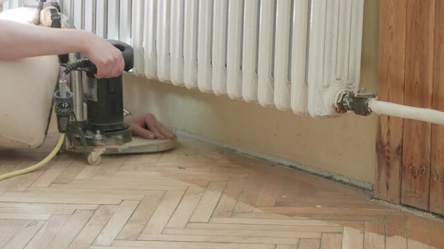 Work on restoring a large area of parquet floor in a public building