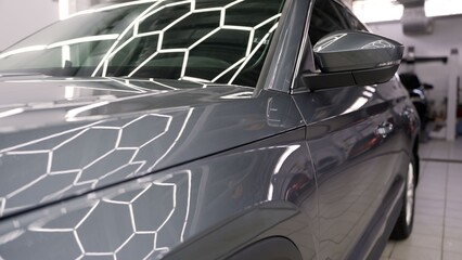 Black car body repair process in professional workshop