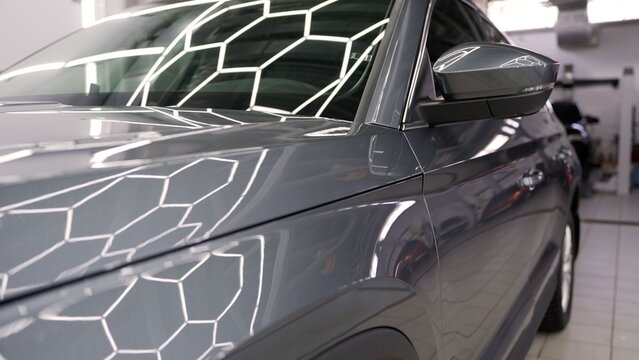 Black car body repair process in professional workshop