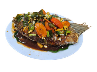 A whole fried fish topped with colorful stir-fried vegetables and a rich brown sauce, served on a light blue plate.