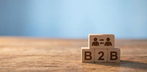 B2B concept represented by wooden letter blocks on table, symbolizing business-to-business relationships, corporate sales models, professional services, enterprise marketing, trade partnerships, and c