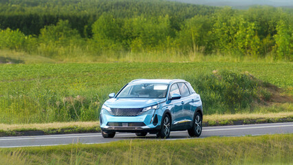 Fototapeta premium Modern European city SUV on rural highway