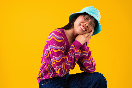 Beautiful asian woman portrait, happy asian woman posing wearing colorful patterned sweater - Powered by Adobe