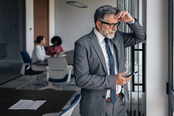 Stressed businessman suffering headache and thinking in office
