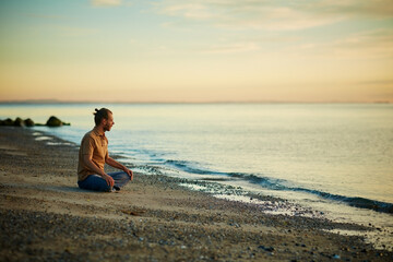 Meditation, break and man in nature, beach and routine for inner peace, space or spiritual awareness. Outdoor, mindfulness and person with stress relief, ocean and wellness on vacation and relax