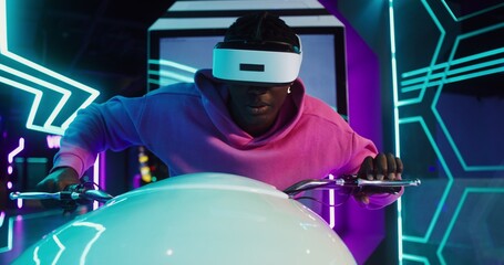 A man in a virtual reality headset on a motorcycle simulator in VR studio