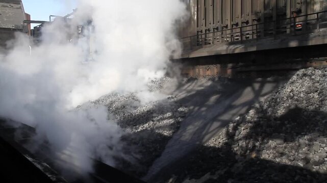Coke oven plant in operation producing hard but reactive metallurgical coke for blast furnace use.