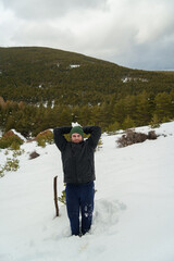 Man holding snowball ready to throw in winter mountain landscape