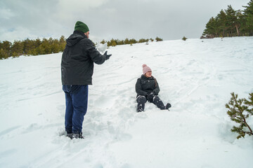 People playing in snow enjoying winter outdoor activity