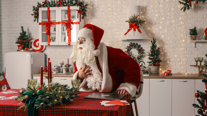 Santa Claus feeling unwell in a festive kitchen, holding his chest