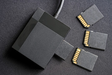 Flat lay of photographer&rsquo;s or content creator&rsquo;s equipment: a card reader and flash memory cards for file backup and data transfer. Modern technology concept. Photo