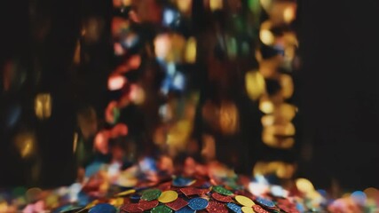 Colorful confetti falling against dark background - Powered by Adobe