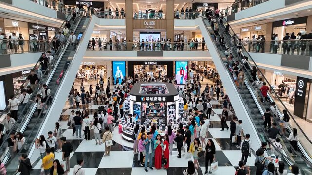 Crowded shopping mall interior with escalators