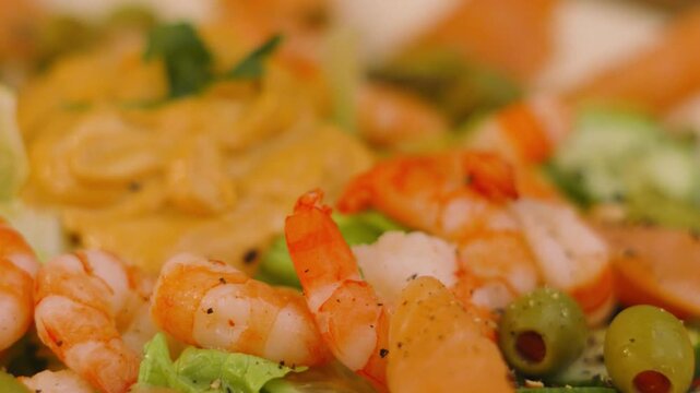 Delicious King Prawns and Salmon with Olives and Pickles with Marie Rose Sauce for Dipping in the Middle. Seafood Platter Served at Parties. Seasoned with Black Pepper.