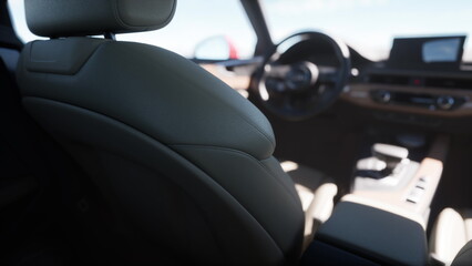 Soft leather seats and a sleek design create a welcoming atmosphere in this cars interior. The setting is perfect for a road trip under the clear blue sky.