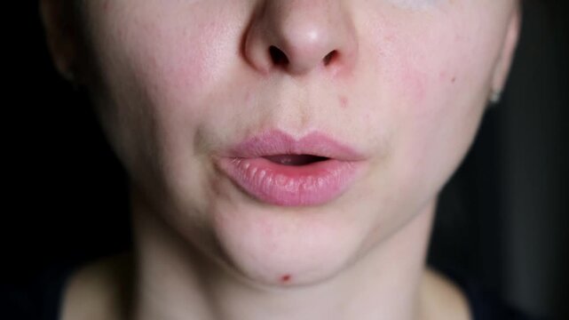 Closeup woman breathing superficially fast through her mouth. Panic attack or panicked person stress state high adrenaline. Breathing rules during childbirth. Face exercises, vocal and speech therapy.