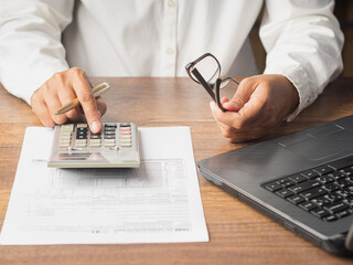 Businesswoman signing contract document on office desk.