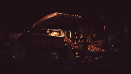 A treasure chest stands open in a dark space, revealing a collection of shimmering artifacts. The...