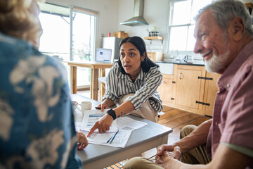 Financial advisor meeting with senior couple at home