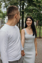 Obraz premium A young couple in love walking in the park, vertical image