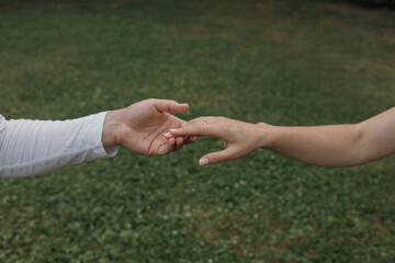 Hands of a couple in love. The concept of a man and a woman joining hands in love.